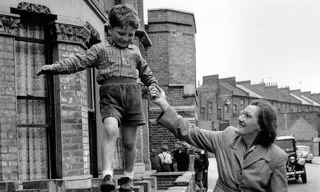 1950s England: a boy walks on a wall