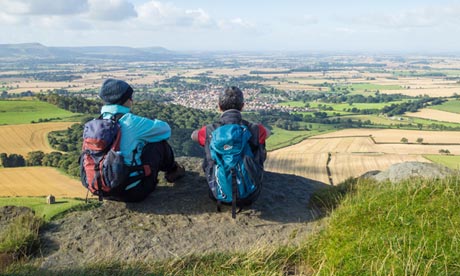 ikers overlooking Great Ayton village from top of Roseberry Topping in North Yorkshire