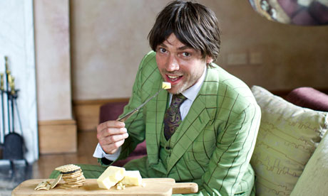 Alex James eating cheese and crackers