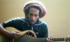 Bob Marley playing guitar