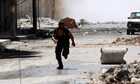 A man runs for cover during clashes in Aleppo