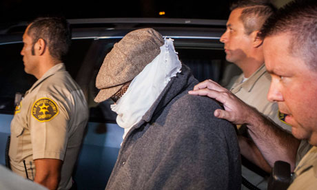 Hidden agenda ... Nakoula Basseley Nakoula, thought to be the maker of Innocence of Muslims, is escorted from his home last week by LA police officers. Photograph Bret Hartman, Reuters