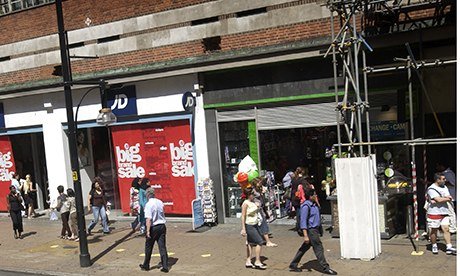 A few people walking along Oxford Street
