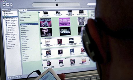 (FILES) A man holds an iPod as he sits i