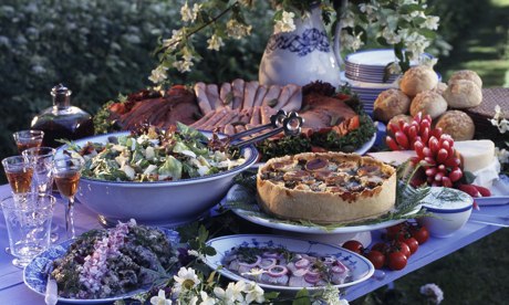 A lot of food on a table in a garden