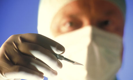 Surgeon holding scalpel