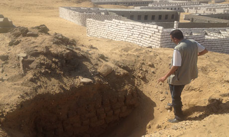 An archaeologist looks into a fresh tomb