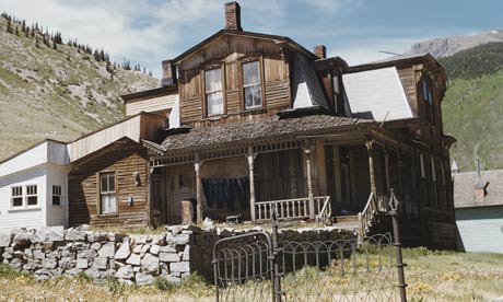 Hand-built wooden house with mountains in Colorado
