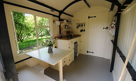 Seat, table and wooden walls in Kate Humble's shepherd's hut