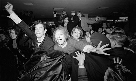 Beatles' fans are restrained by police at Kennedy Airport.