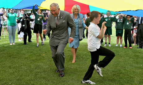 Charles and Camilla cut a caper during a ‘parachute game’ on a 2012 visit to Guernsey. 