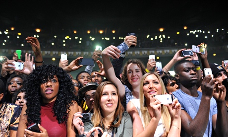 Phone-wielding fans record a concert at London’s Hammersmith Apollo.  
