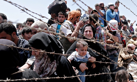 Syrian refugees wait to cross the border into Turkey. Samar Yazbek crossed the other way…