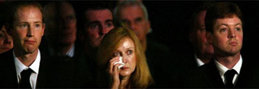 Robin Cook's wife Gaynor and sons Peter (left) and Chris listen to Gordon Brown's eulogy. Photograph: David Cheskin / AFP