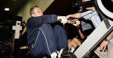 Tony Blair exercises on a rowing machine