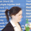 A nurse passes an information sign at the Royal Infirmary, Stoke, an NHS hospital. Photograph: David Sillitoe