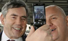 Gordon Brown has his photograph taken by a rail passenger at St Pancras station in London, as he sets off on a tour of the country on January 7 2009. Photograph: Toby Melville/Reuters