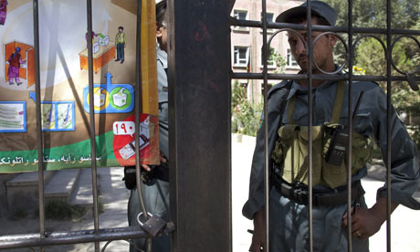 An Afghan policeman guards a polling station in Kabul