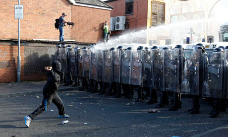 Nationalist youths and police in riot gear clash in the Ardoyne area of north Belfast 12 July, 2011