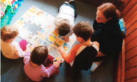 Nursery worker with small children