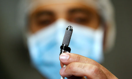 Ssurgeon holds the world's smallest artificial heart