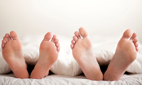 Couple's feet in bed