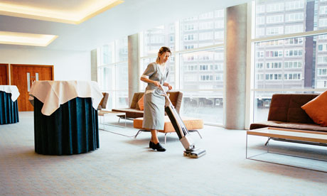 Woman vacuuming in conference room