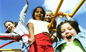 Four girls play on a climbing frame