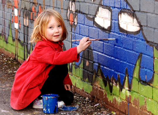 It's Your Community: Emma Shaw painting a mural