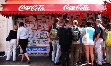 Migrant workers seek employment at a Post Office noticeboard in Ravenscourt Park, West London