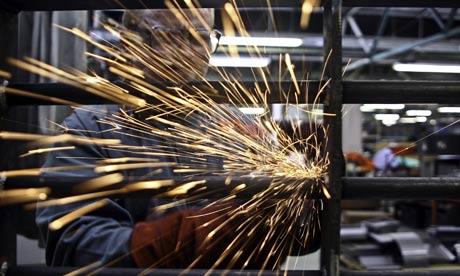 A prisoner at Coldingley makes prison gates in the steel workshop