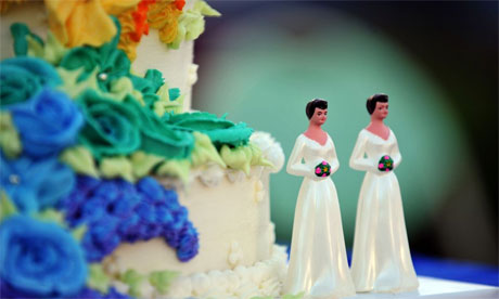 A wedding cake with statuettes of two women is seen during the demonstration in West Hollywood, California