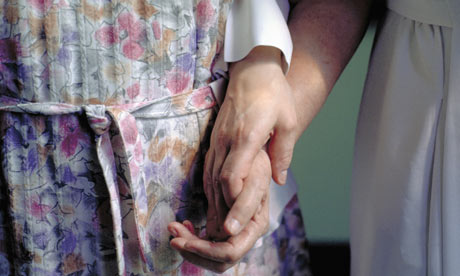 Nun Holding the Hand of Elderly Woman 
