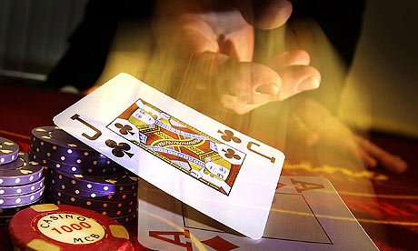 A dealer dealing a card in a casino