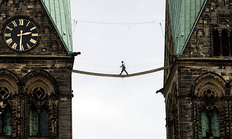 A man walks over a plank bridge between the towers of the cathedral in Bremen, northern Germany,
