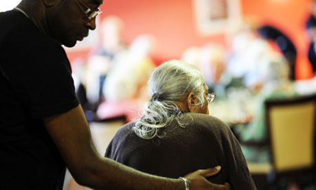 Older woman being helped in a care home