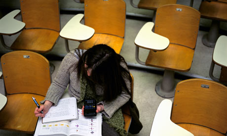 Girl sits alone in lecture hall