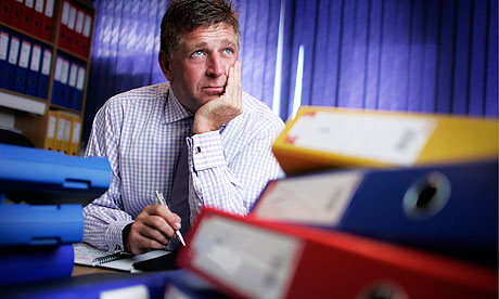 man stressed with files