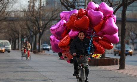 A vendor with heart-shaped balloons