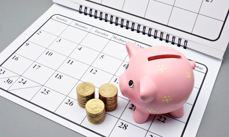 Piggy bank and coins on calendar