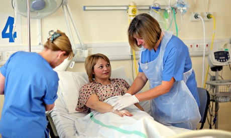 A staff nurse inserts a cannula in a patient’s hand at Velindre Cancer Centre, Cardiff, south Wales