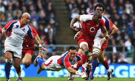 Ugo Monye of England goes through the tackle from Pierre Hola of Pacific Islanders at Twickenham.