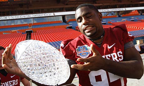 University of Oklahoma defender Alan Davis poses with the BCS Championship trophy