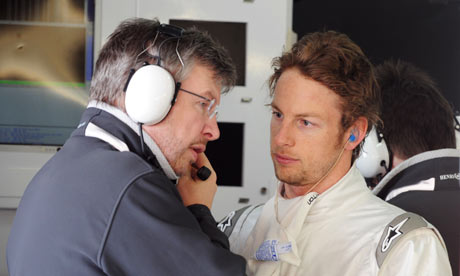 Team Brawn's boss Ross Brawn L talks with Jenson Button during testing 