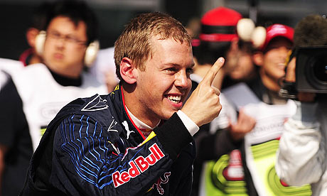 Red Bull driver Sebastien Vettel celebrates his pole position after 