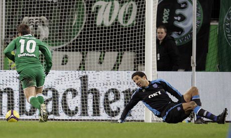 Zvjezdan Misimovic scores Wolfsburg's third goal as Portsmouth's David James looks on