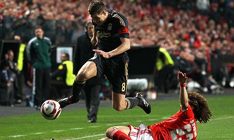 Steven Gerrard, left, skips over a tackle from David Luiz