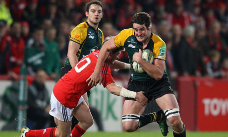 Calum Clark of Northampton charges upfield past Ronan O'Gara