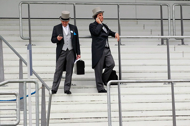 Ascot day 4: Two racegoers talk on their mobile phones on the 4th day of Royal Asco