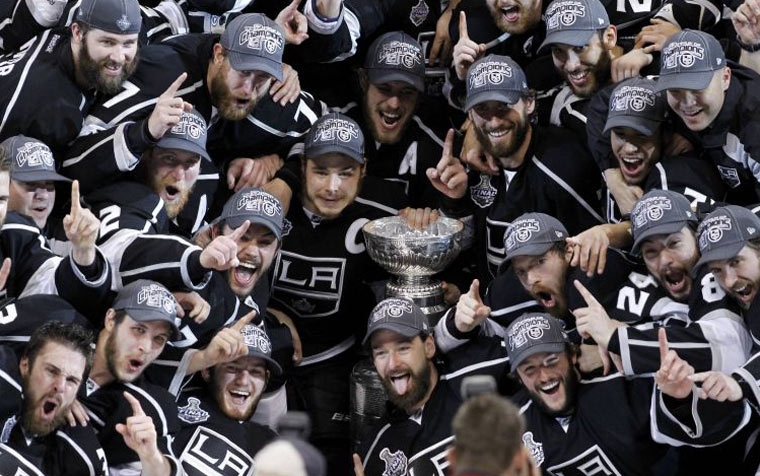 Los Angeles Kings players pose with the Stanley Cup 
